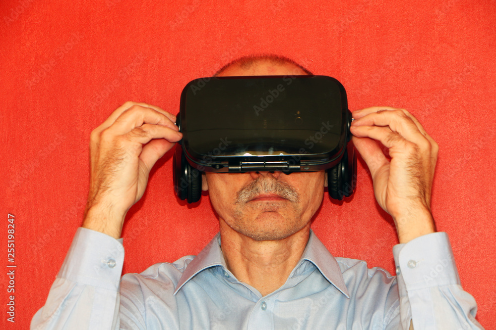 The man in a virtual reality glasses gesturing The man in a virtual reality glasses gesturing