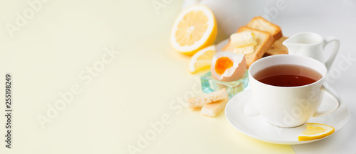 Breakfast with boiled egg, toasts, tea