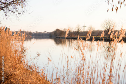 weitblick auf den fluss und die brücke in fresenburg emsland deutschland fotografiert an einem lauen sommerabend während eines sonnenuntergangs photo