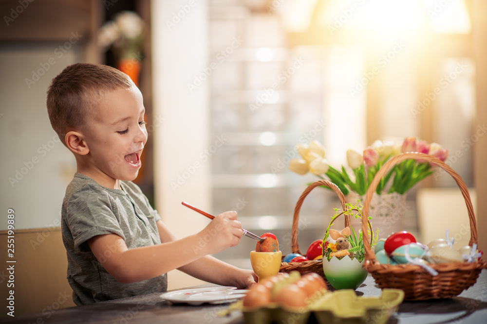 Cute boy painting Easter eggs Cute boy painting Easter eggs