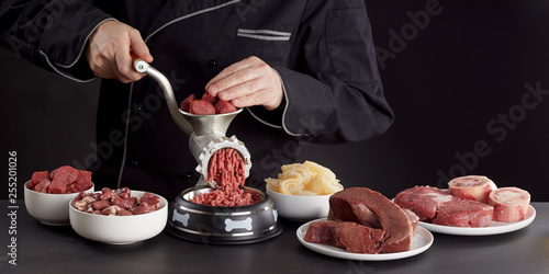 Man preparing healthy raw meat for barf dog food