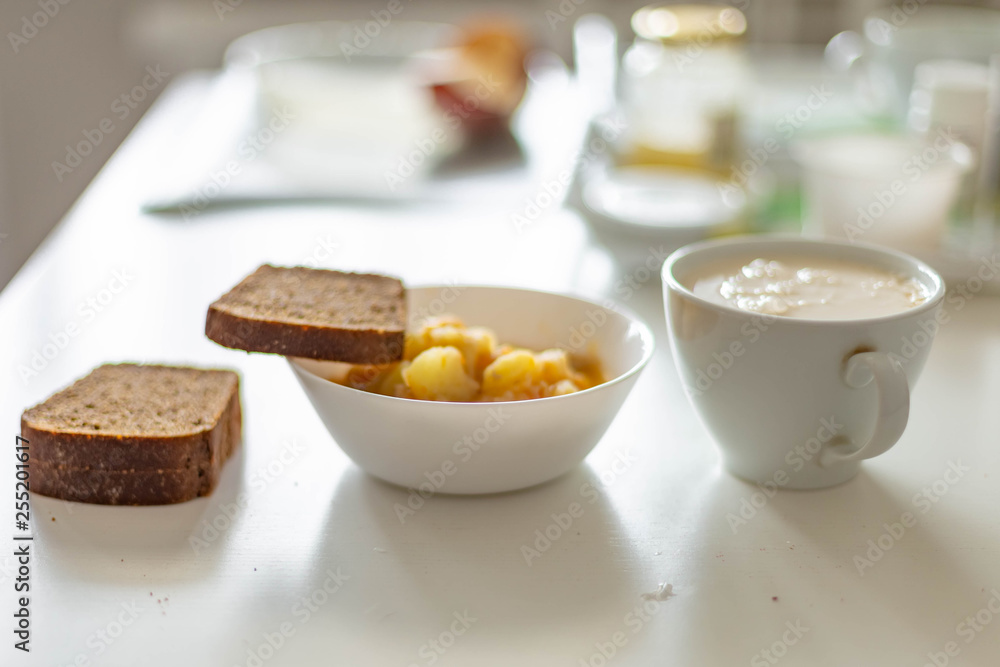 potatoes with meat, Chuvash dairy product and three pieces of Borodino bread on a white table