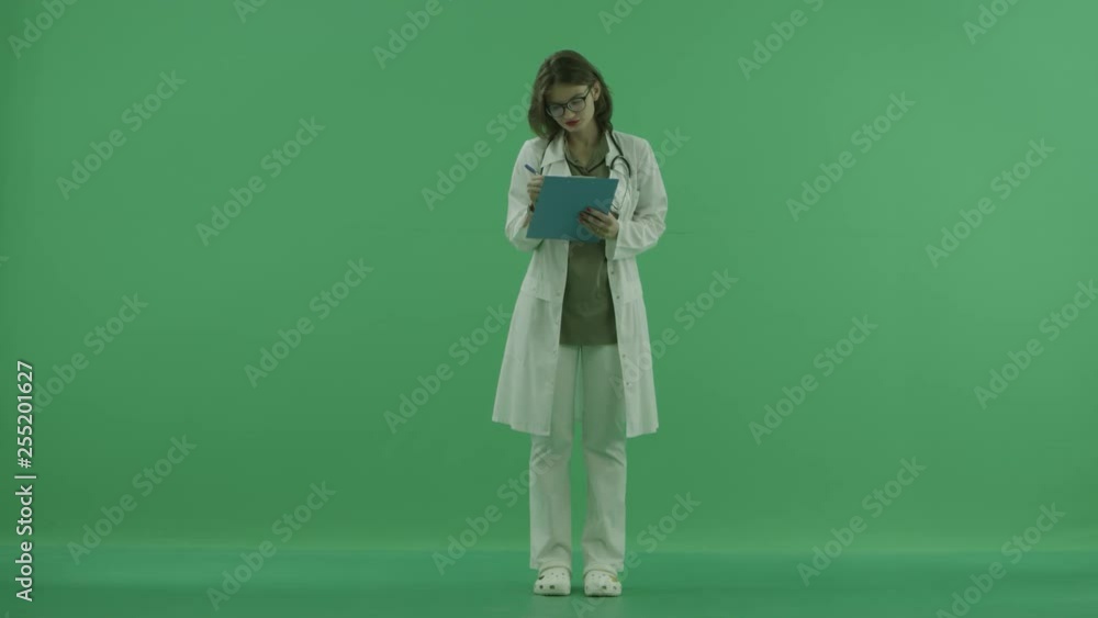 the doctor is conducting a survey and making notes on green screen the doctor is conducting a survey and making notes on green screen