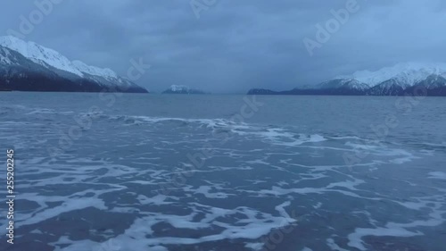 Footage of evening tide in Alaska moving water in bay around with storm weather approaching 