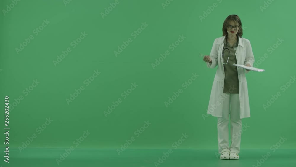 the doctor explains something and then points to something with her hand on green screen the doctor explains something and then points to something with her hand on green screen