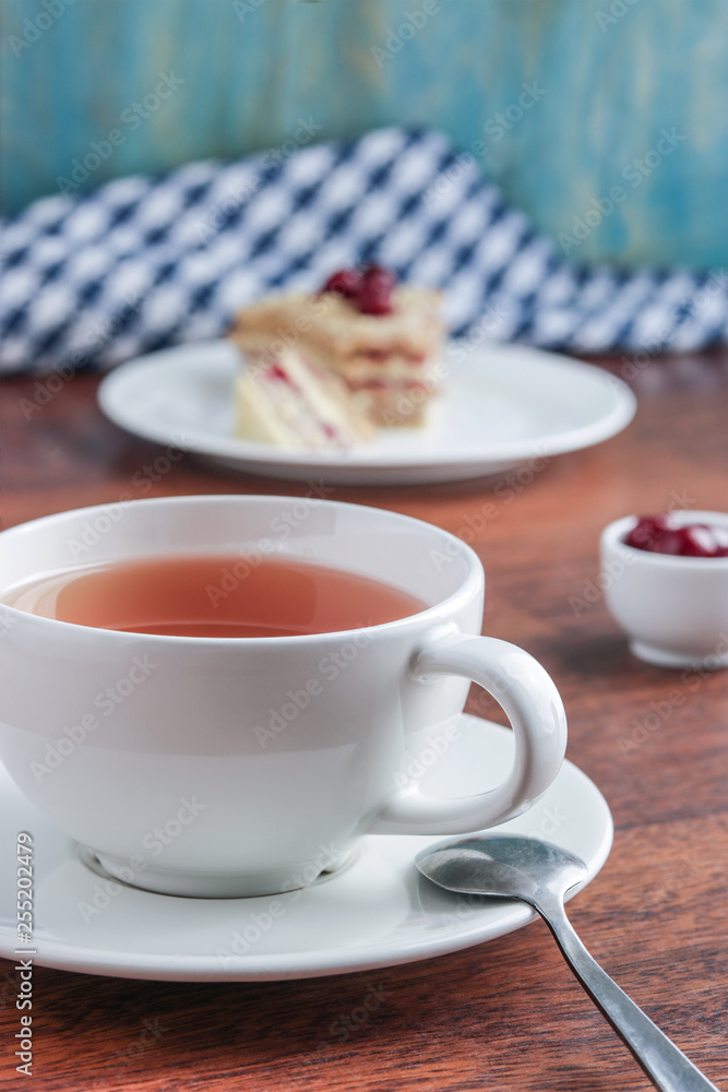 cup of tea piece of cake on the plate vertical composition selective focus cup of tea piece of cake on the plate vertical composition selective focus
