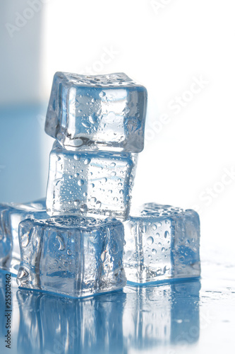 vertical stack of ice cubes on wet surface