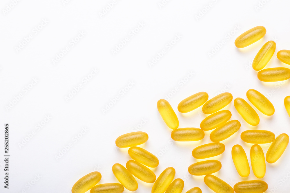 Omega 3 capsules on white background Fish oil Yellow softgels Vitamin D, E, A supplement Concept of healthcare Omega 3 capsules on white background Fish oil Yellow softgels Vitamin D, E, A supplement Concept of healthcare