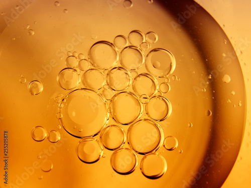 Yellow bubbles and drops of oil background, kitchen pattern, orange beverage background.
