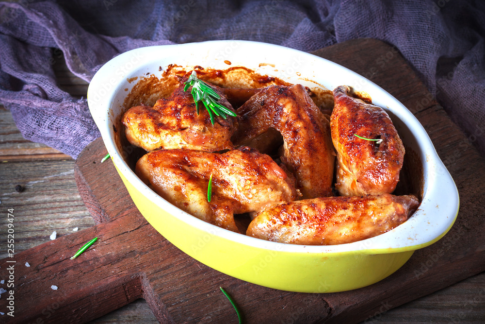 Chicken Wings, Oven Baked and Grilled. Homemade Tasty Food. Wood Table Background, Rustic Still Life Style. Close up Chicken Wings, Oven Baked and Grilled. Homemade Tasty Food. Wood Table Background, Rustic Still Life Style. Close up