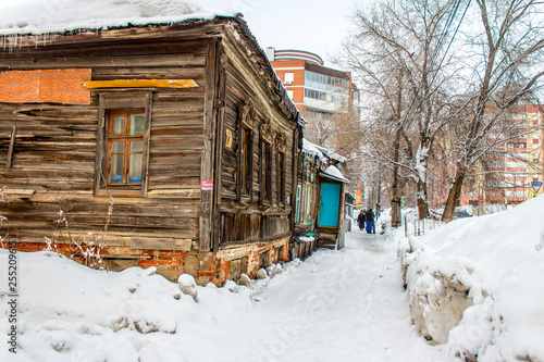 snow-covered old wooden and brick houses © aleksa3136