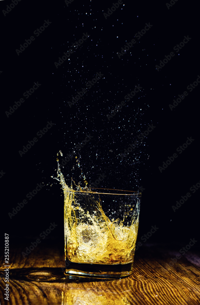 Isolated shot of whiskey on wooden background Isolated shot of whiskey on wooden background