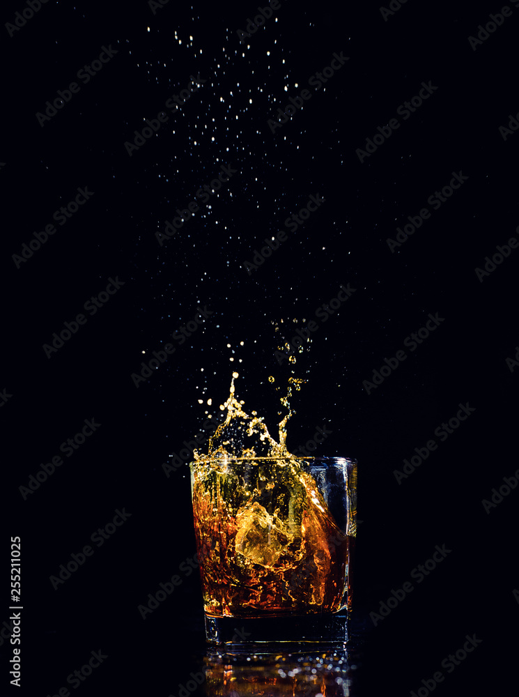 Isolated shot of whiskey with splash on black background Isolated shot of whiskey with splash on black background