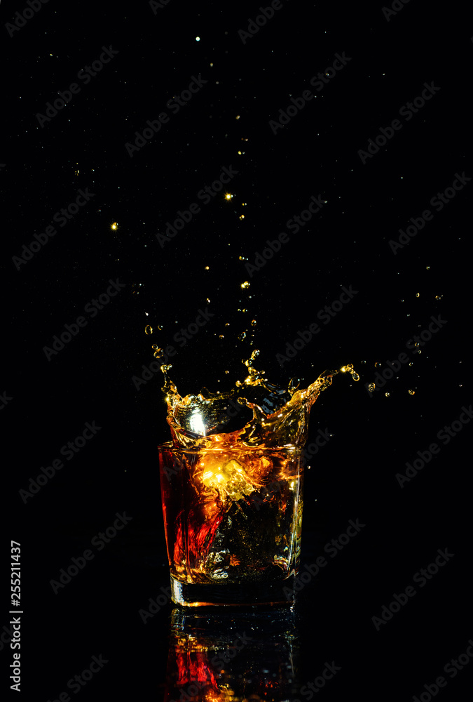 Isolated shot of whiskey with splash on black background Isolated shot of whiskey with splash on black background