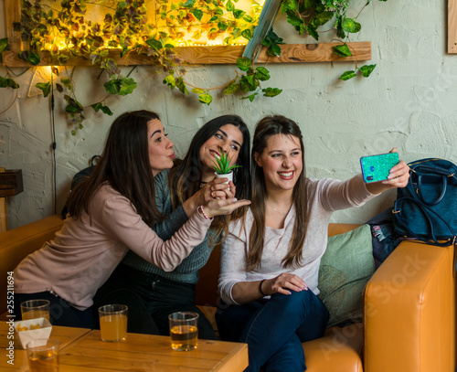 Happy friends group drinking beer and taking selfie at brewery bar restaurant