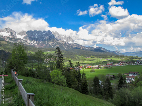 Panorama from the village of Elmau -Tyrol near the city of Innsbruck with green sunny Austrian Alps in Tyrol with snowy mountains in the background under blue sky photo