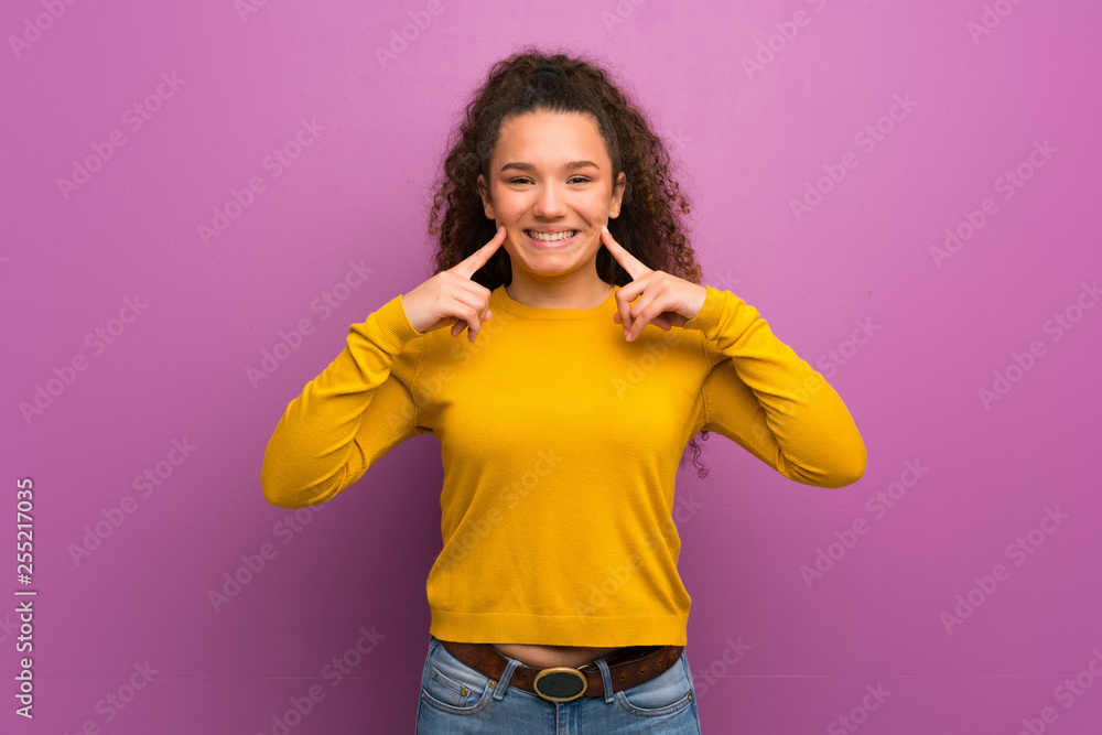 Teenager girl over purple wall smiling with a happy and pleasant expression Teenager girl over purple wall smiling with a happy and pleasant expression
