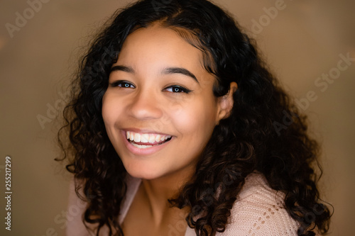 Beautiful,  Biracial High School Senior with Curly Hair Smiling with Teeth