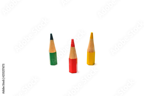 Three colored very small pencils on a white background. The concept of waste-free use.
