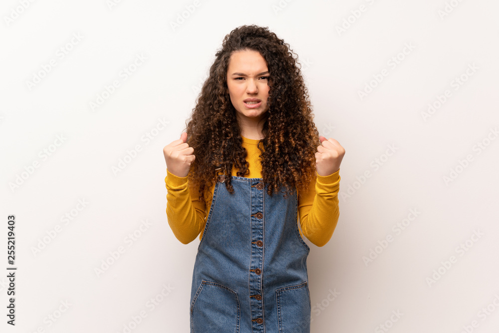 Teenager girl with red sweater over white wall frustrated by a bad situation Teenager girl with red sweater over white wall frustrated by a bad situation