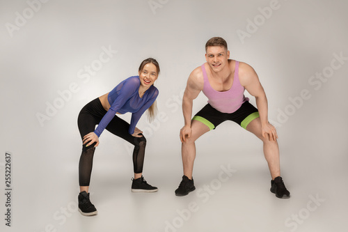 Young sporty couple in colorful sportswear resting after training