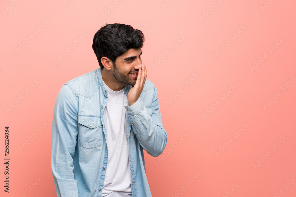 Young man over pink wall smiling a lot Young man over pink wall smiling a lot