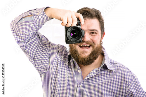 portrait of big handsome bearded photographer taking photo with professional DSLR camera, isolated on white