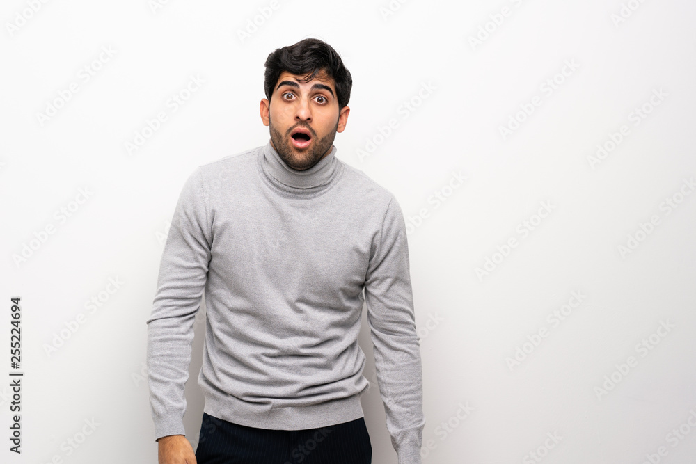 Young man over isolated white wall with surprise facial expression Young man over isolated white wall with surprise facial expression