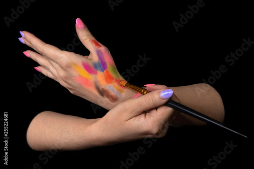 Closeup artist painter painting with brush on her hand in a studio. Creative painter girl. learning painting concept