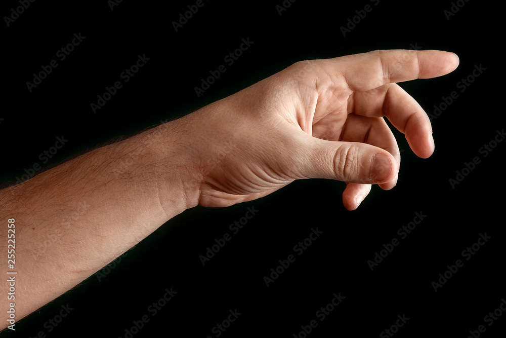 Man's hand touching or pointing to something isolated on black background. Close up. High resolution. Man's hand touching or pointing to something isolated on black background. Close up. High resolution.