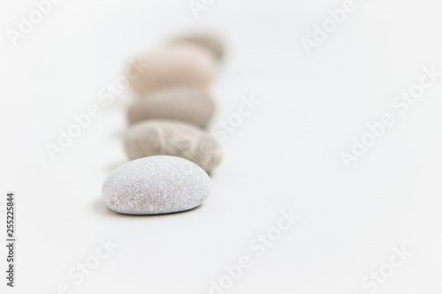 Pebbles in a row on the white ground