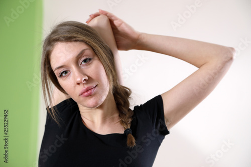 Half-length Shot Of Woman In Black T-shirt Doing Stretching Hands Exercises