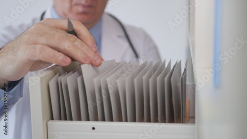 Close up Image with Doctor Hands Searching Contracts and Medicines Records