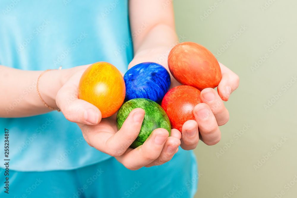 Girl holding colorful eggs. Bright Easter eggs in the hands of a woman. Close-up Girl holding colorful eggs. Bright Easter eggs in the hands of a woman. Close-up