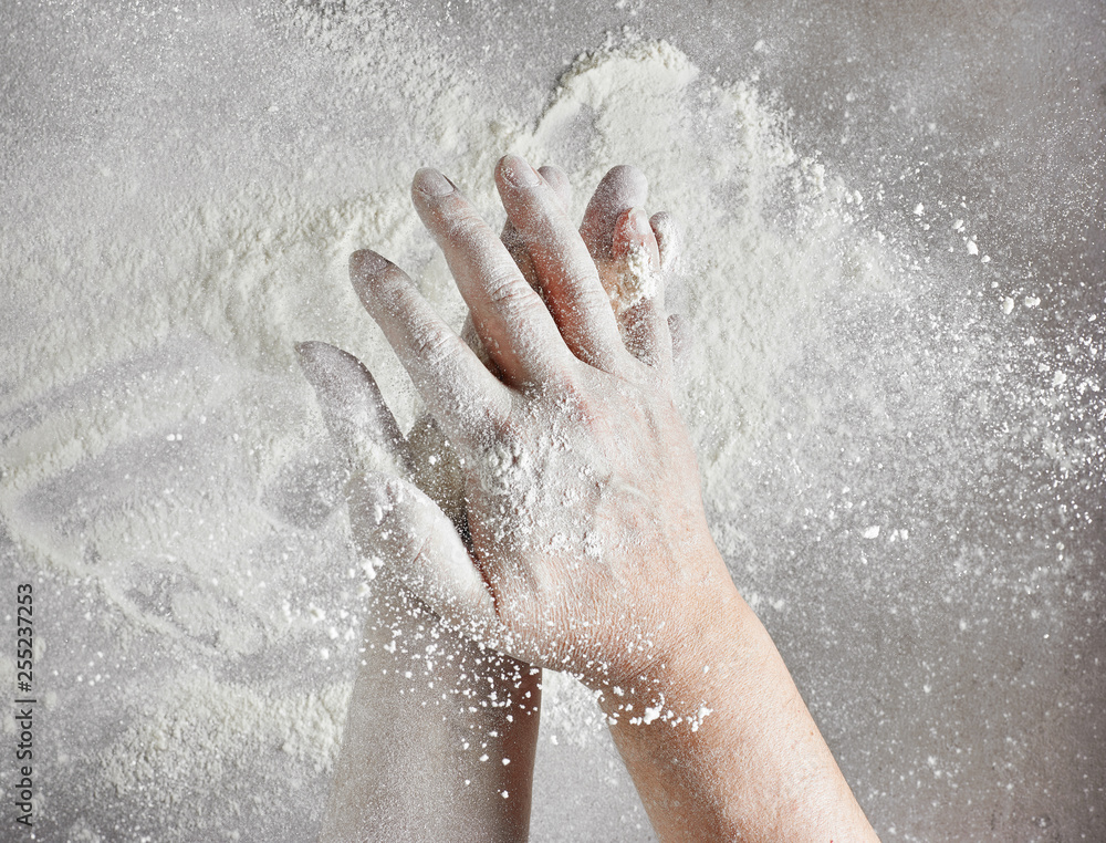 Fototapeta premium baker hands with flour in motion