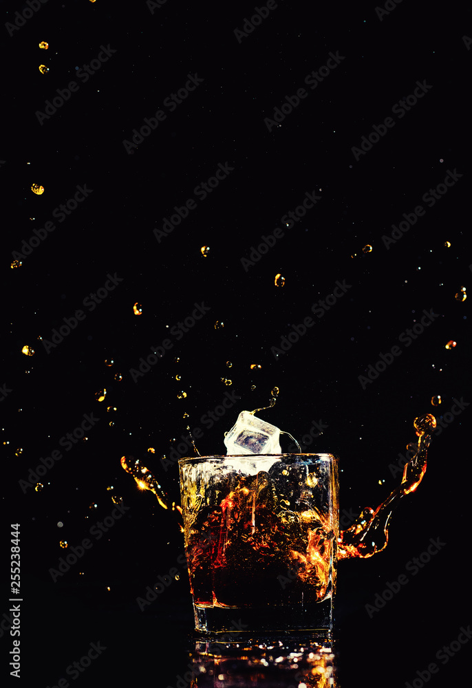 whiskey with splash on black background whiskey with splash on black background
