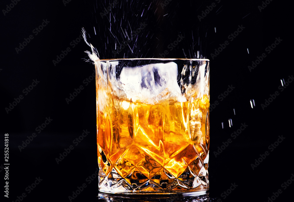 whiskey with splash on black background, brandy in a glass whiskey with splash on black background, brandy in a glass