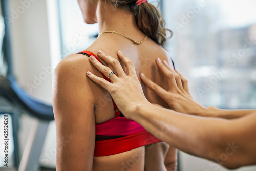 Physiotherapist giving back massage to her patient in clinic photo