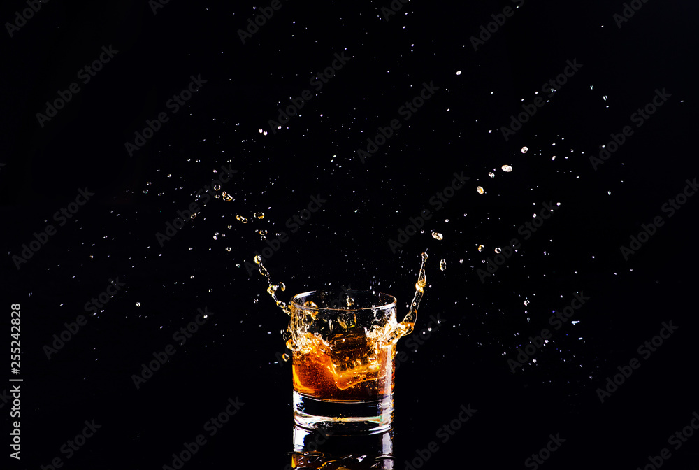 whiskey with splash on black background, brandy in a glass whiskey with splash on black background, brandy in a glass