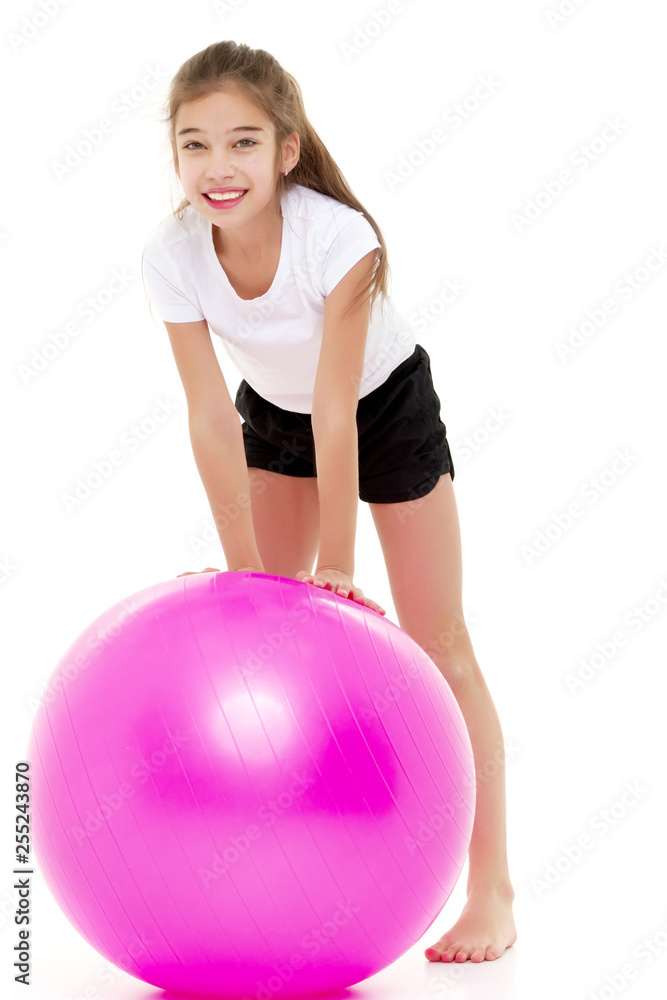 little girl doing exercises on a big ball for fitness. little girl doing exercises on a big ball for fitness.