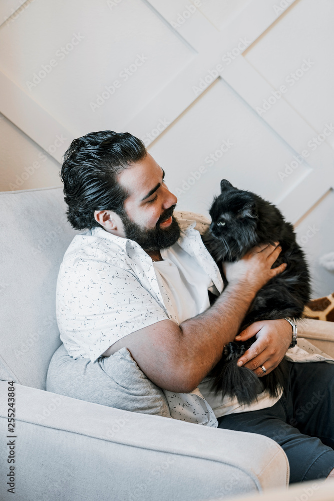 Man with cat sitting on armchair Man with cat sitting on armchair