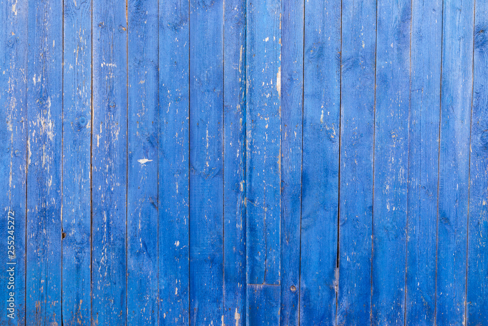The texture of the wooden wall is blue with peeling paint The texture of the wooden wall is blue with peeling paint
