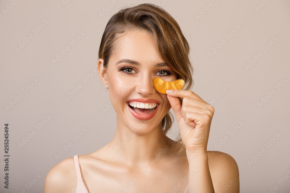 Happy woman using eye applicator mask. Happy woman using eye applicator mask.