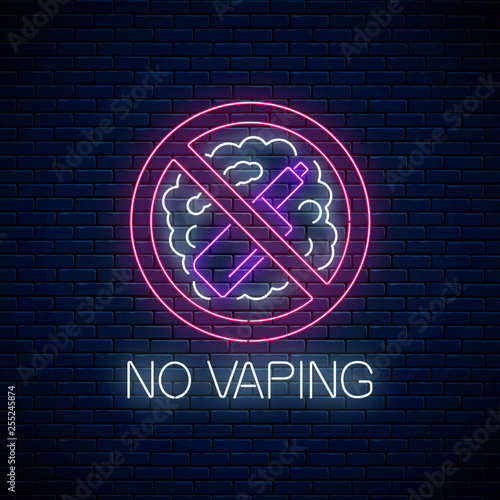 Glowing neon no vaping sign on dark brick wall background. Vape free area symbol. Signboard of no smoking place.