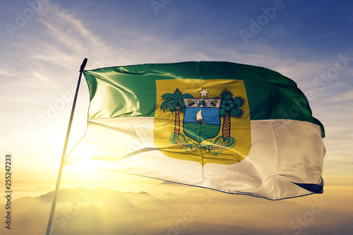 Rio Grande do Norte state of Brazil flag waving on the top sunrise mist fog photo