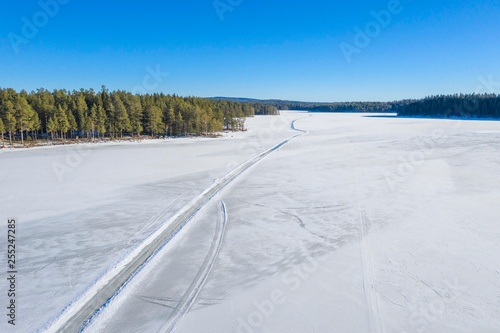 Winter road on lake drone photo