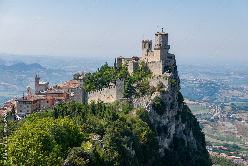 Guaita tower in the fortifications of San Marino on Monte Titano, with the City of San Marino on the left.