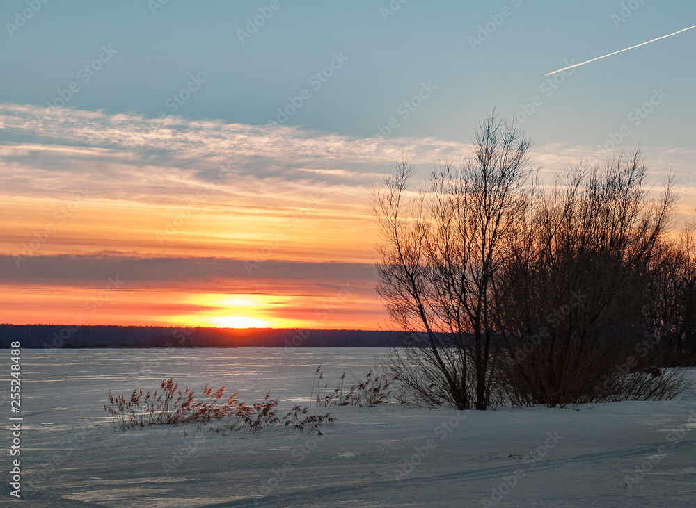 Beautiful sunset on the greate Volga river. Lot of ice on the winter river Beautiful sunset on the greate Volga river. Lot of ice on the winter river