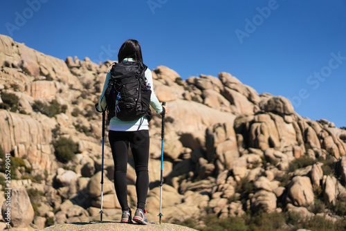 A young woman hiker in La Pedriza, National Park of mountain range of Guadarrama in Manzanares El Real, Madrid, Spain.