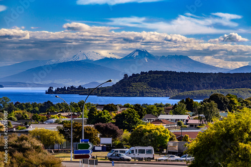 New Zealand, North Island. Taupo town and Lake Taupo, Mt Ngauruhoe, Mt Tongariro and Mt Ruapehu in the background
